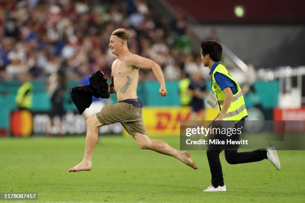 Spectator invades the pitch during the Rugby World Cup 2019 Group A game between Scotland and Samoa at Kobe Misaki Stadium on September 30, 2019 in...