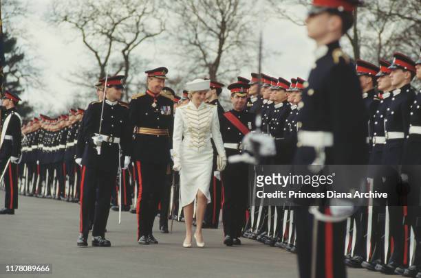 Diana, Princess of Wales wearing a military-style suit by Catherine Walker and a hat by Graham Smith at Kangol to the Royal Military Academy...