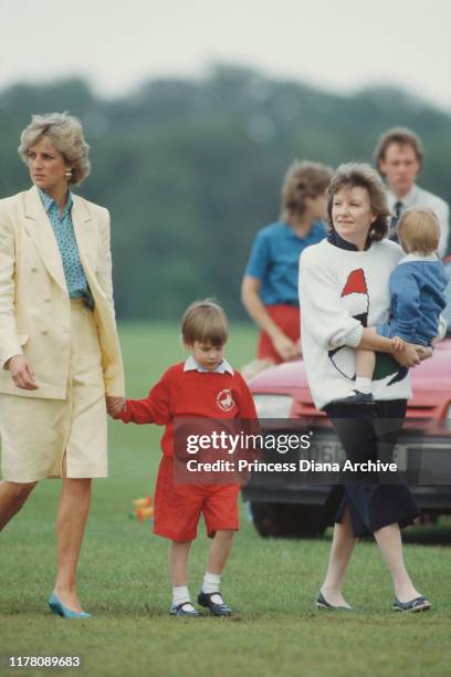 Diana, Princess of Wales with her sons Prince William and Prince Harry at the Guards Polo Club in Windsor, UK, May 1987.