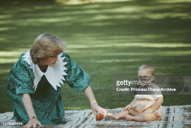 Diana, Princess of Wales with her 10-month-old son Prince William on the lawn of Government House in Auckland, New Zealand, 23rd April 1983.