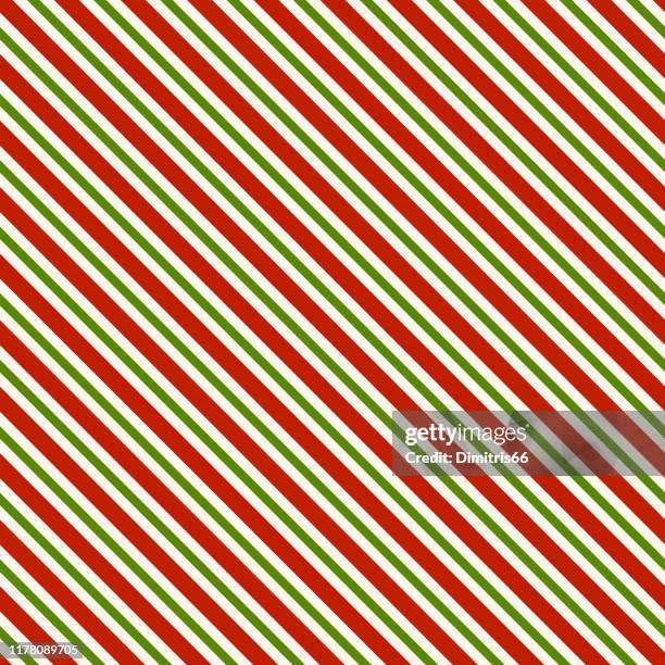 red green and white diagonal lines - seamless pattern background - candy cane stock illustrations