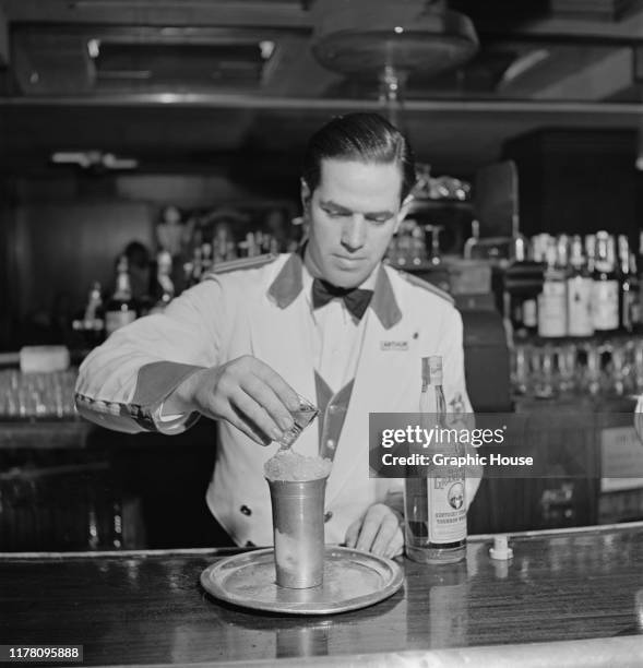 Bartender makes a cocktail with Old Grand-Dad Kentucky bourbon whiskey at the New Yorker Hotel in New York City, USA, 20th April 1942.