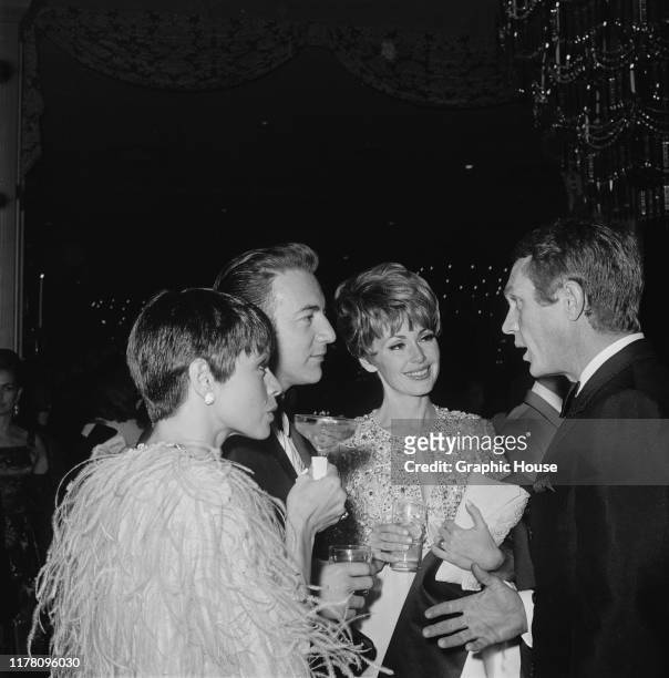 American actor Steve McQueen and his wife, actress Neile Adams talking to singer Bobby Darin and actress Barbara Rush at the premiere after-party for...