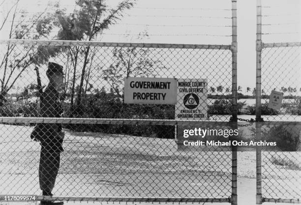 Guard and a 'Government Property' sign at the gate of the Monroe County Civil Defense Emergency Operation Center in Key West, Florida, where radar...