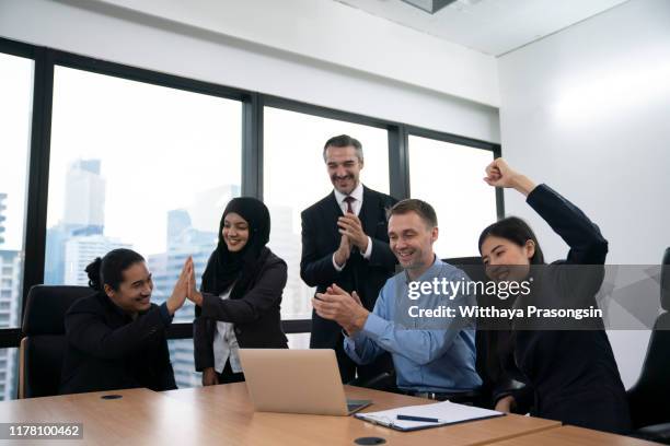 group of diversity people team smiling and excited in success - employee satisfaction stock pictures, royalty-free photos & images