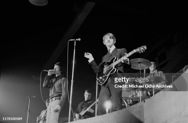 Singer Allan Clarke, guitarist Tony Hicks and drummer Bobby Elliott of English band The Hollies perform at the opening of The World, Murray the K's...