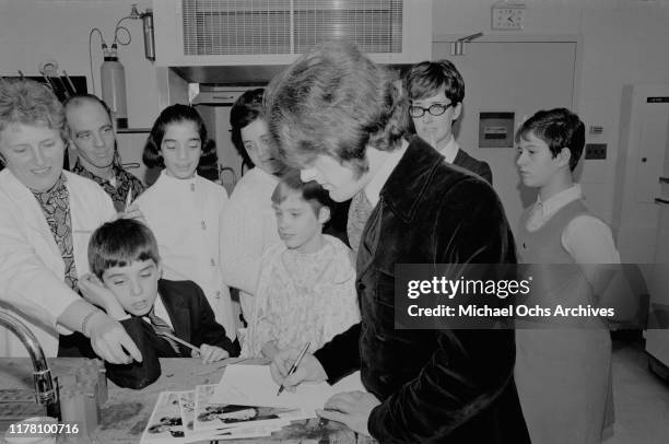 American pop musician Tommy James of the band Tommy James and the Shondells signs autographs for young fans at a children's hospital, circa 1967.