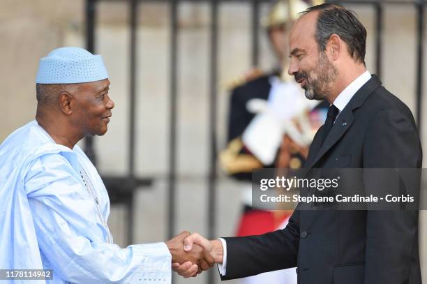 Former Malian President Amadou Toumani Toure is greeted by France's Prime Minister Edouard Philippe as he arrives to attend a church service for...