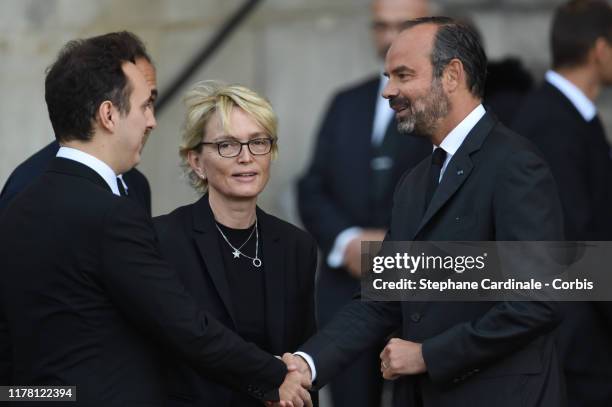 Martin Rey-Chirac is greeted by France's Prime Minister Edouard Philippe next to Claude Chirac as he arrives to attend a church service for former...