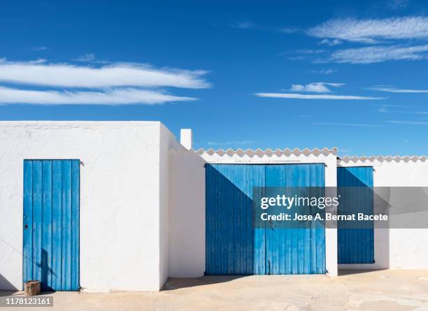 white facade with blue doors and windows. - formentera stock pictures, royalty-free photos & images