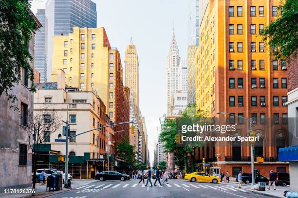 lexington avenue and chrysler building in new york city, usa - new york stockfoto's en -beelden