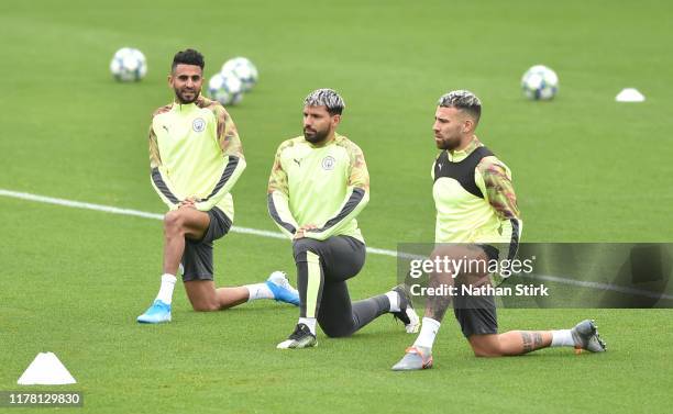 Riyad Mahrez, Sergio Aguero and Nicols Otamendi of Manchester City takes part during a training session at Manchester City Football Academy at The...