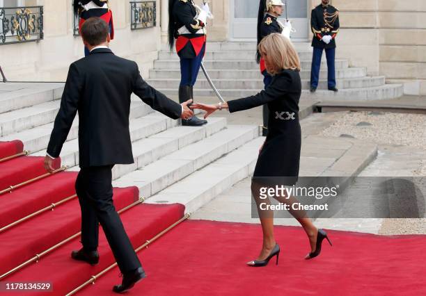 French President, Emmanuel Macron and his wife Brigitte Macron welcome former French President Francois Hollande prior to a lunch at the Elysee...