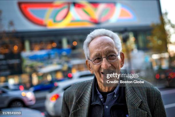 Frank Stella poses in front of his mural reproduction of his 1970 painting, "Damascus Gate ", along Seaport Boulevard in Boston on Oct. 24, 2019.