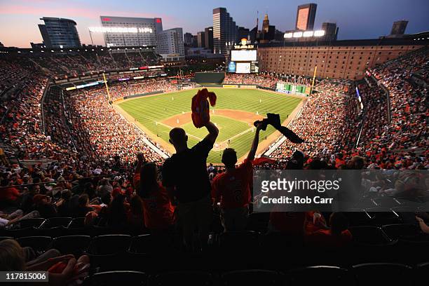 Fans cheer during the sixth inning between the Baltimore Orioles and St. Louis Cardinals at Oriole Park at Camden Yards on June 30, 2011 in...