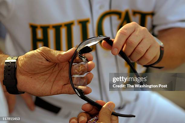 Luis Salazar, Manager of the Lynchburg Hillcats in Lynchburg, VA on June 15, 2011. Luis is showing his shatterproof glasses he wears whenever he is...