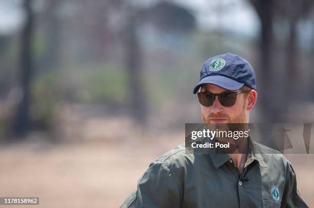Prince Harry, Duke of Sussex watches an anti-poaching demonstration exercise conducted jointly by local rangers and UK military deployed on Operation...