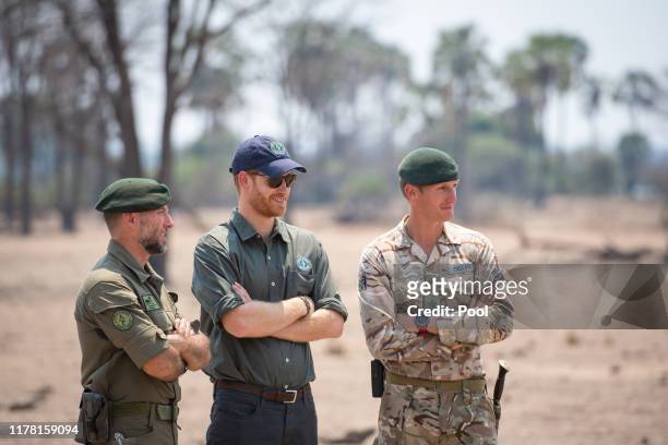 Prince Harry, Duke of Sussex watches an anti-poaching demonstration exercise conducted jointly by local rangers and UK military deployed on Operation...
