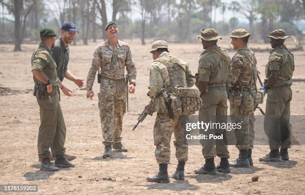 People role playing ivory poachers during an anti-poaching demonstration exercise conducted jointly by local rangers and UK military, watched by the...