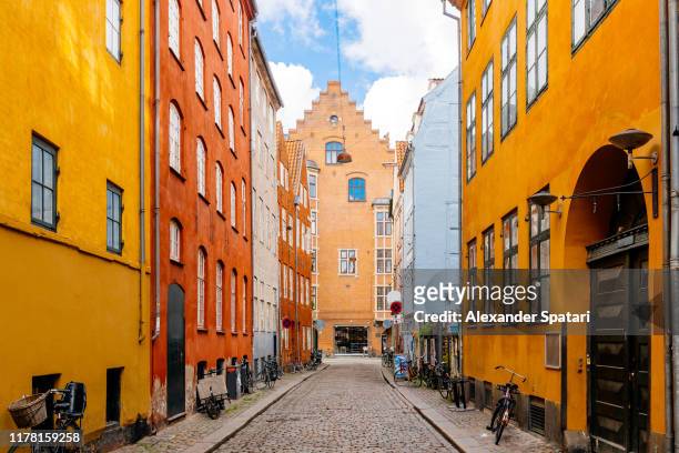 colorful vibrant street in copenhagen, denmark - kopenhagen stock-fotos und bilder
