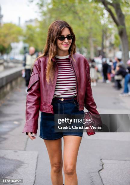 Gala Gonzaelz seen wearing bordeaux leather jacket, denim shorts, striped top outside Valentino during Paris Fashion Week Womenswear Spring Summer...
