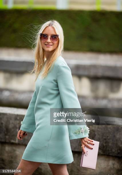 Charlotte Groeneveld seen wearing dress with long sleeves, pink clutch outside Valentino during Paris Fashion Week Womenswear Spring Summer 2020 on...