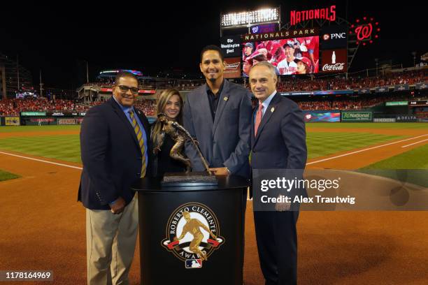 Roberto Clemente Award winner Carlos Carrasco of the Cleveland Indians poses with Luis Clemente, son of the late Roberto Clemente and Commissioner...