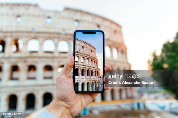 taking picture of coliseum using smart phone, personal perspective view - ancient rome city stock pictures, royalty-free photos & images