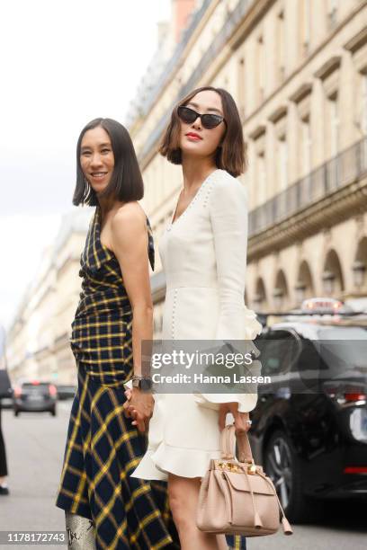 Eva Chen wearing Monse dressParis Texas boots and Chriselle Lim wearing white mini dress outside Giambattista Valli during Paris Fashion Week...