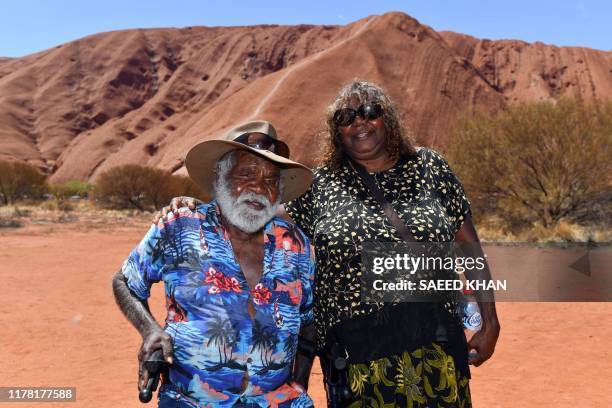 Traditional Aboriginal owners of Uluru-Kata-Tjuta, the Anangu, gather in front of the Uluru, also known as Ayers rock, after a permanent ban on...