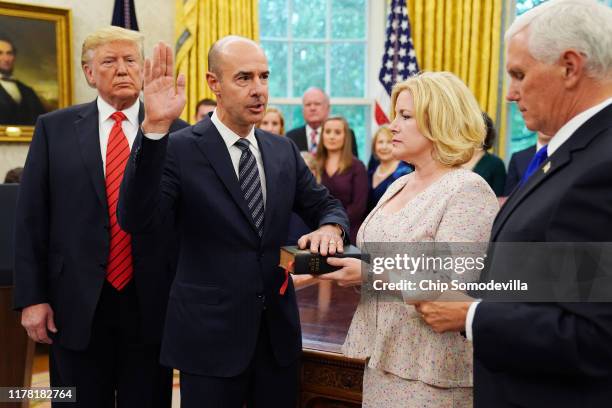 President Donald Trump watches as Labor Secretary Eugene Scalia is ceremonially sworn in by Vice President Mike Pence as his wife Patricia Scalia...