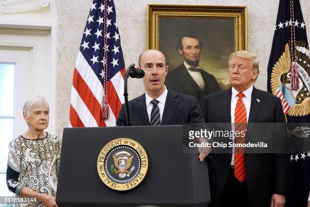 Labor Secretary Eugene Scalia delivers remarks while standing in between his mother, Maureen Scalia, and U.S. President Donald Trump before Scalia is...
