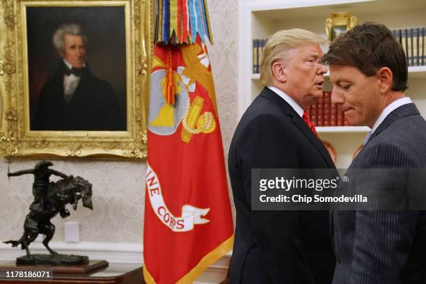 President Donald Trump passes White House Principal Deputy Press Secretary Hogan Gidley before answering a reporters' question about a whistleblower...