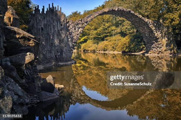 devil's bridge in the nature park with circle reflection in the water - bogen stock pictures, royalty-free photos & images