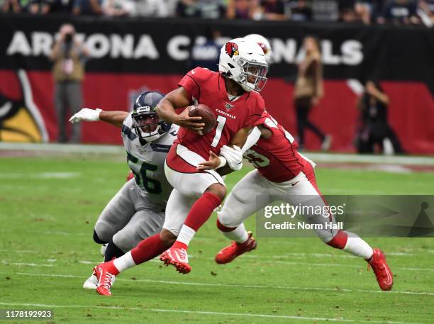 Kyler Murray of the Arizona Cardinals runs with the ball while avoiding a tackle by Mychal Kendricks of the Seattle Seahawks at State Farm Stadium on...