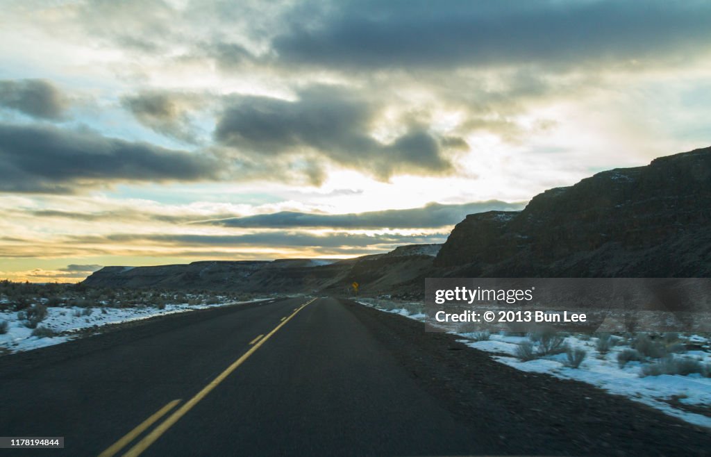 Straight road ahead with vibrant sunset sky