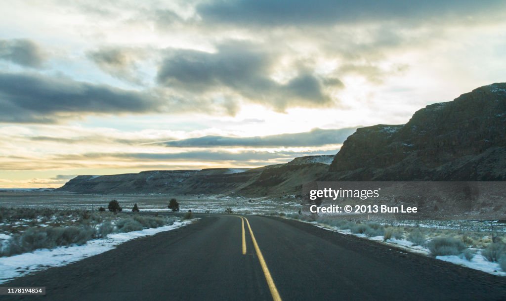Straight road ahead with vibrant sunset sky