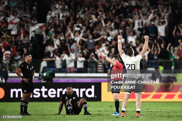 England's back row Mark Wilson reacts beside New Zealand's fly-half Richie Mo'unga and New Zealand's wing Sevu Reece after winning the Japan 2019...