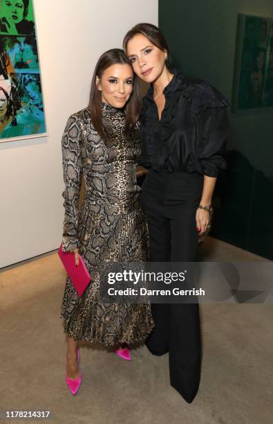 Eva Longoria and Victoria Beckham attend Victoria Beckham and Sotheby's celebration of Andy Warhol with Don Julio 1942 at her Dover Street store, on...