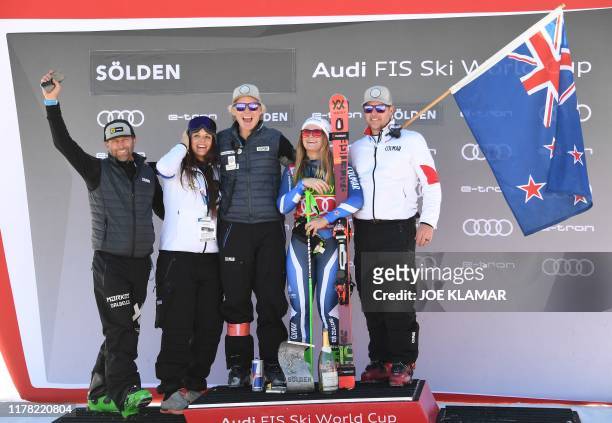 Winner New Zealand's Alice Robinson poses with her team on the podium of the Women's giant slalom at the FIS ski World cup on October 26, 2019 in...