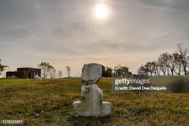 Grave site marker indicating a plot of individual lots of buried remains stands on Hart Island on October 25, 2019 in New York City. Hart Island,...