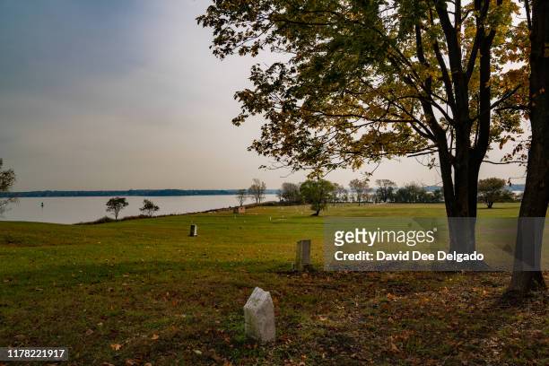 Grave site markers indicating plots of individual lots of buried remains stand on Hart Island on October 25, 2019 in New York City. Hart Island,...