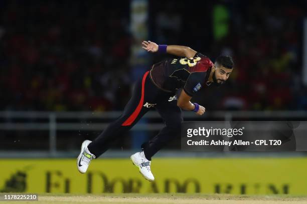 In this handout image provided by CPL T20, Ali Khan of Trinbago Knight Riders bowls during the Hero Caribbean Premier League match between Trinbago...