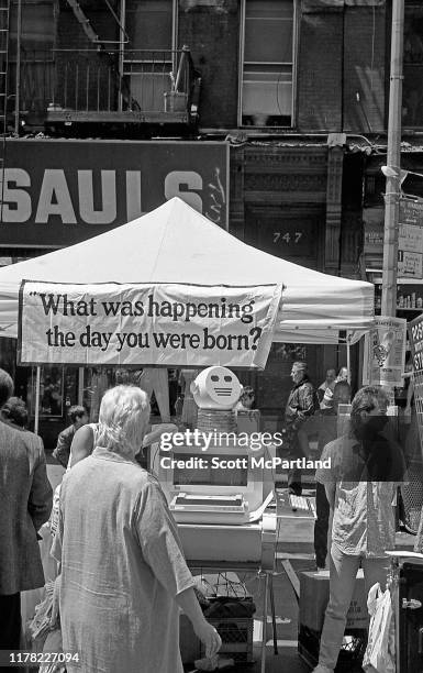 Pedestrians stop at one of the novelty vendor stalls 9th Avenue in Hell's Kitchen during the International Food Festival, New York, New York, May 16,...