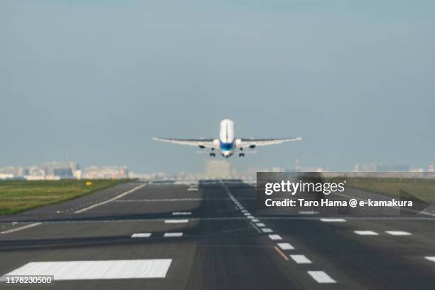 the airplane taking off tokyo haneda international airport in japan - tokyo international airport ストックフォトと画像