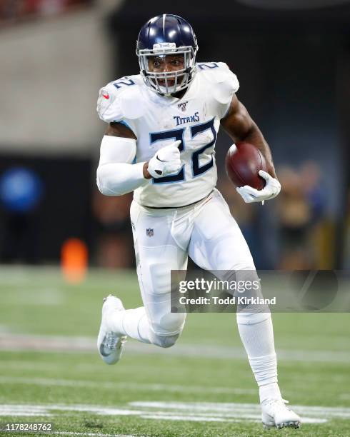 Derrick Henry of the Tennessee Titans rushes in the first half of an NFL game against the Atlanta Falcons at Mercedes-Benz Stadium on September 29,...