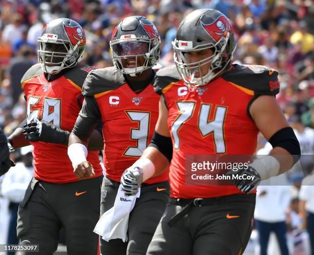 Demar Dotson of the Tampa Bay Buccaneers, Jameis Winston and Ali Marpet step to the line of scrimmage against the Los Angeles Rams at Los Angeles...