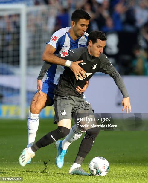 Marko Grujic of Berlin challenges for the ball with Sebastian Rudy of Hoffenheim during the Bundesliga match between Hertha BSC and TSG 1899...