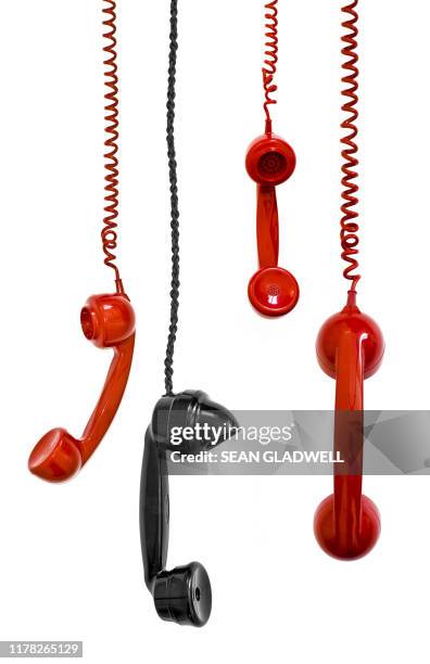 hanging telephone receivers - old fashioned telephone stock pictures, royalty-free photos & images