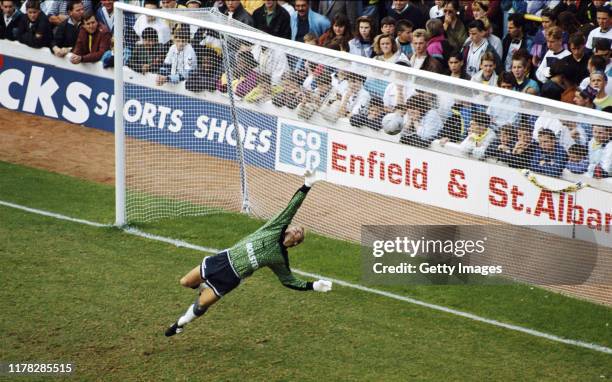 Spurs goalkeeper Erik Thorstvedt in diving action as spectators behind the goal look on during a First Division match against Aston Villa at White...